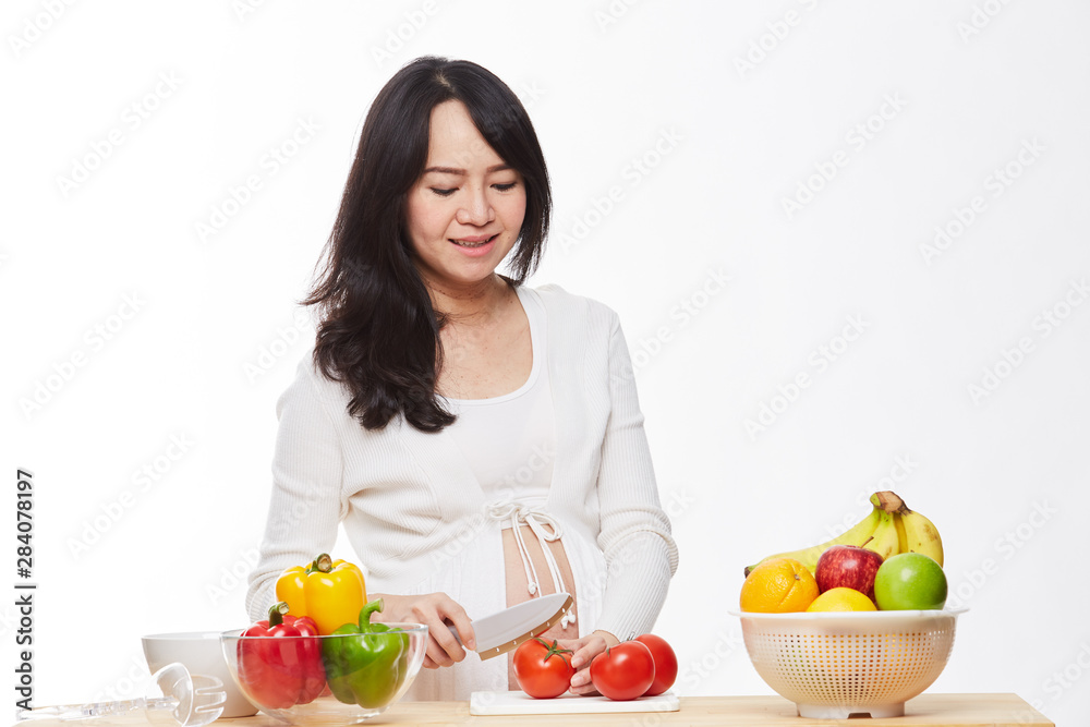 Belly women prepare food on the table.