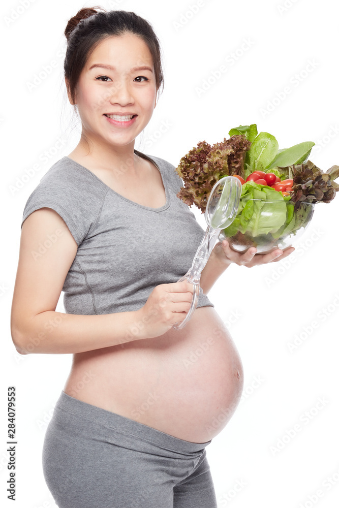 A portrait of a Happy pregnant woman with a bowl of salad A portrait of a Happy pregnant woman with a bowl of salad