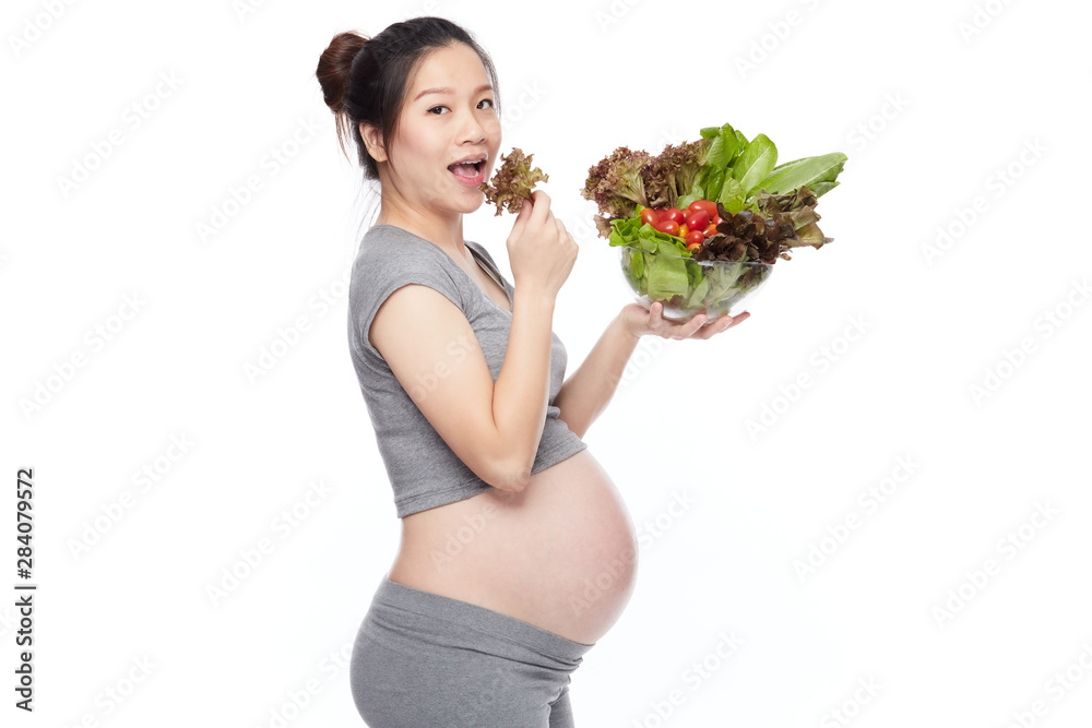 A portrait of a Happy pregnant woman with a bowl of salad A portrait of a Happy pregnant woman with a bowl of salad