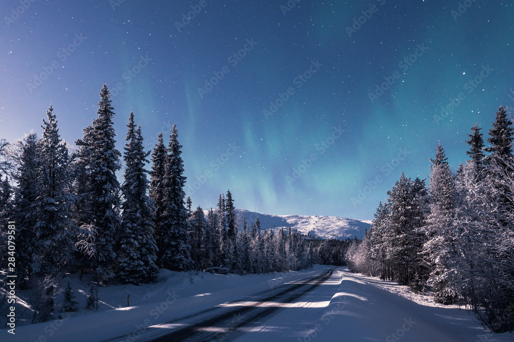 A road leading towards snow covered Pallas fell at winter night in Pallas-Yllästunturi national park in Muonio Finland A road leading towards snow covered Pallas fell at winter night in Pallas-Yllästunturi national park in Muonio Finland