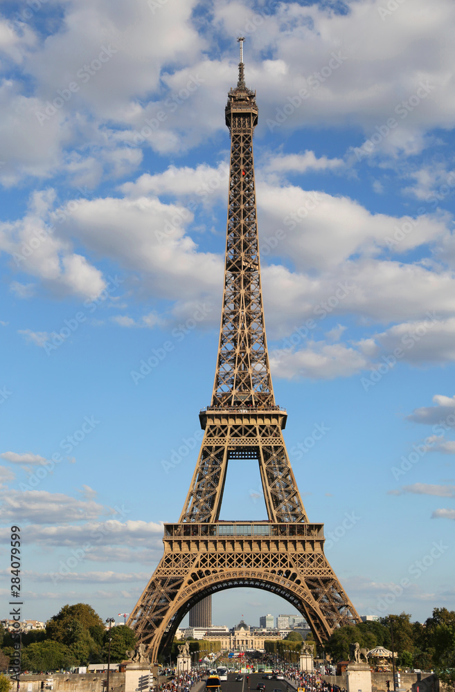 High Eiffel Tower Symbol of Paris in France with some clouds in