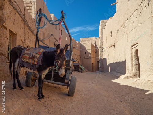 Desert town of Mhamid, Morocco village with nature sand dunes and old muslim mosque in north Africa, old narrow streets, traditional clay mud architecture