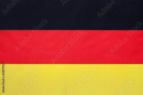 German national fabric flag, textile background. Symbol of international world european country.