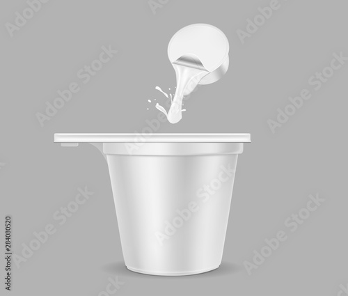 White disposable paper or plastic coffee cup. Single serve cup with cream
