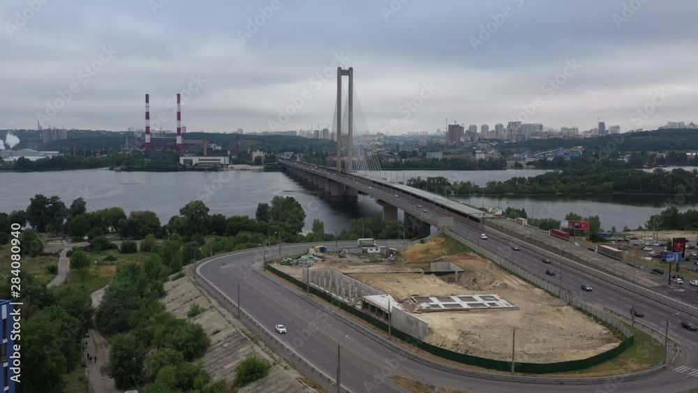 Aerial drone static shot of traffic moving along the Kiev South Bridge over the Dnieper River in Ukraine on an overcast day Aerial drone static shot of traffic moving along the Kiev South Bridge over the Dnieper River in Ukraine on an overcast day