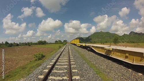 Footage of the new railways in south Cambodia at Touk Meas train station, train is coming on the right side of the tracks in the countryside photo