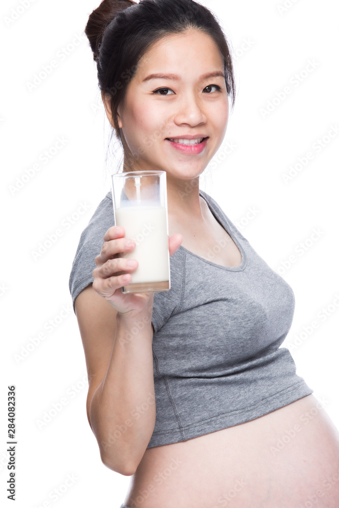 Pregnant woman holding glass of milk in her hand. Pregnant woman holding glass of milk in her hand.