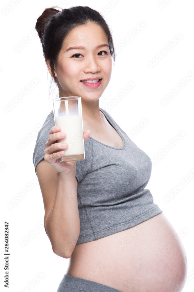 Pregnant woman holding glass of milk in her hand. Pregnant woman holding glass of milk in her hand.