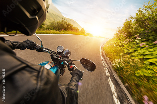 View from motorcycle driver perspective in sunset