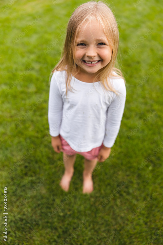 Happy girl on the green grass stock photo Happy girl on the green grass stock photo