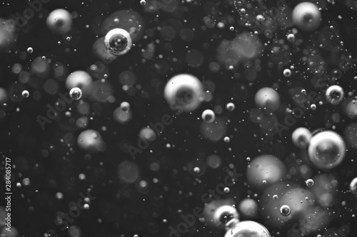 Bubbles of oxygen or air in a dark liquid. For projects with liquid or oil. Macro