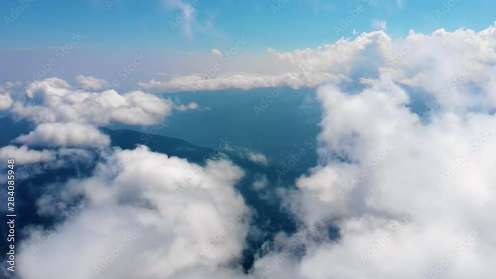 Flying through heavenly beautiful cloudscape. Picturesque timelapse of white fluffy clouds moving softly on the clear blue sky in pure sunshine. Direct view from the cockpit. Flying through heavenly beautiful cloudscape. Picturesque timelapse of white fluffy clouds moving softly on the clear blue sky in pure sunshine. Direct view from the cockpit.