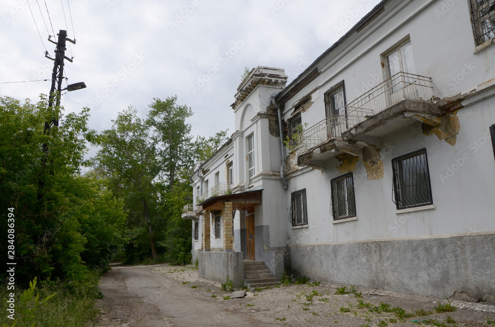 Old dilapidated house in the old district of Magnitogorsk, Soviet construction.