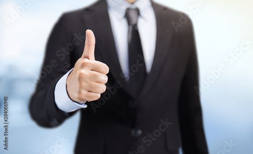 Business man shows thumb up sign gesture