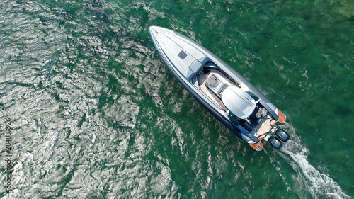 Aerial top view photo of luxury inflatable rib speed boat cruising in open ocean sea
