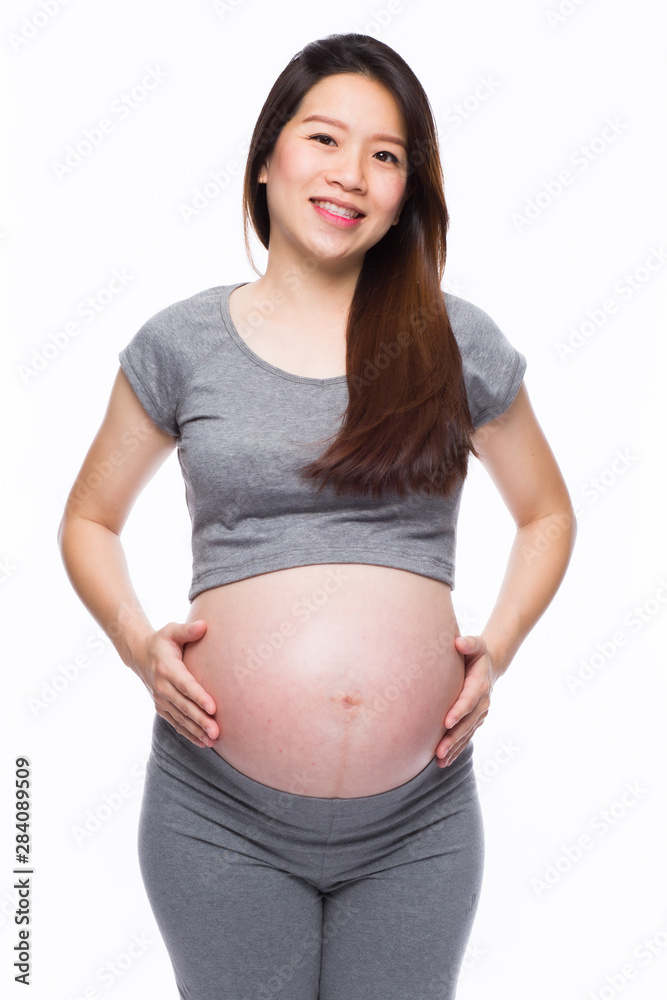 Happy asian pregnant woman smiling and touching her belly Happy asian pregnant woman smiling and touching her belly