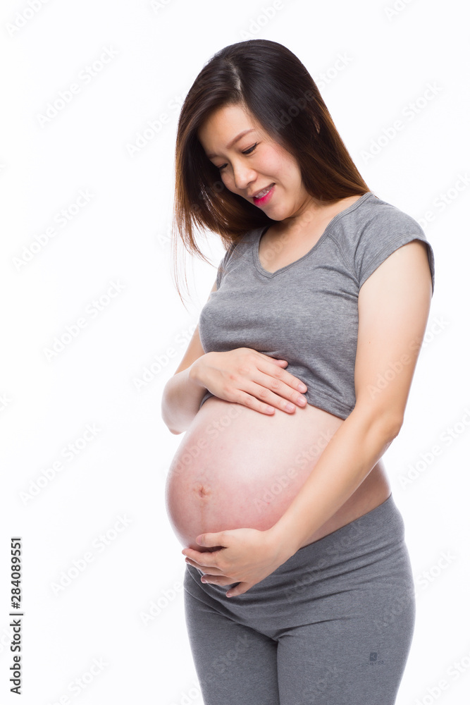 Happy asian pregnant woman smiling and touching her belly Happy asian pregnant woman smiling and touching her belly