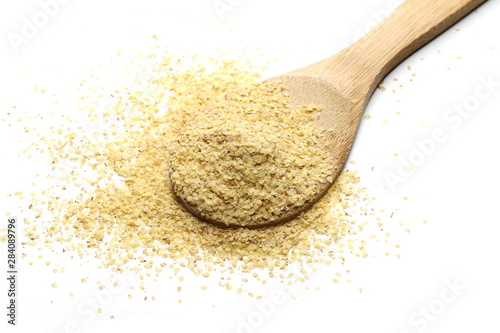 Fotografía Wheat germ pile with wooden spoon isolated on white background