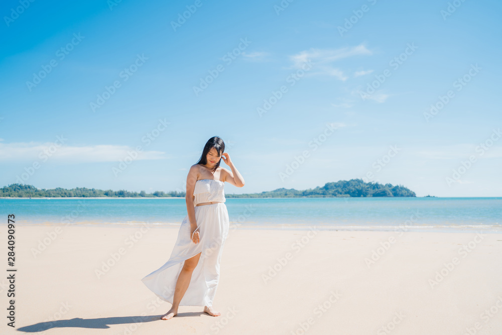 Beautiful young Asian woman happy relax walking on beach near sea. Lifestyle women travel on beach concept. Beautiful young Asian woman happy relax walking on beach near sea. Lifestyle women travel on beach concept.