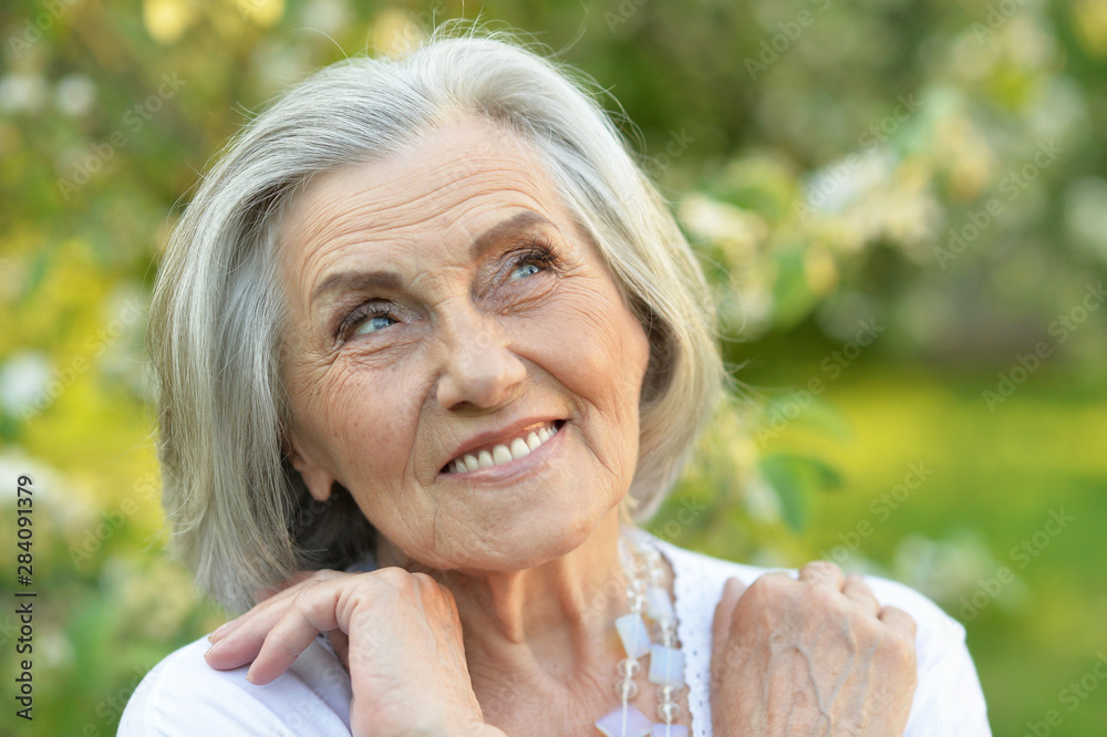 Portrait of senior beautiful woman in spring park Portrait of senior beautiful woman in spring park