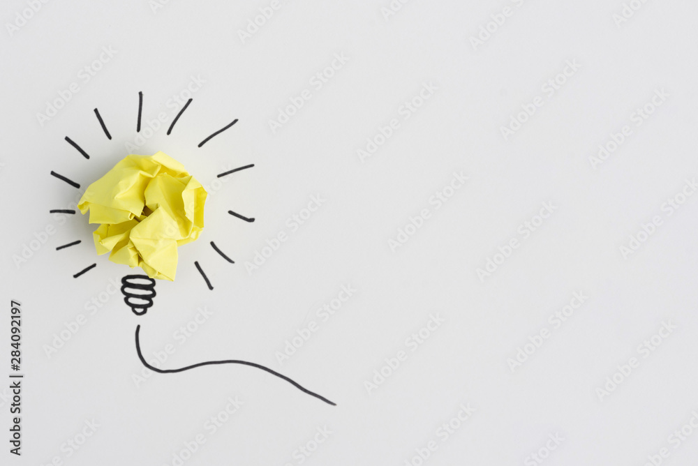 Creative crumpled yellow paper light bulb idea on white background - obrazy, fototapety, plakaty 
