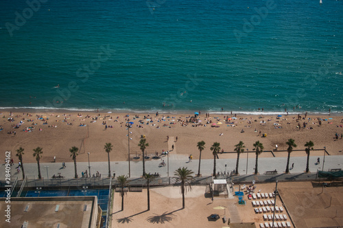 BARCELONA, SPAIN - SEPTEMBER 9, 2014: Aerial view of people on the Barceloneta beach, Mediterranean coastline in Barcelona © krutenyuk