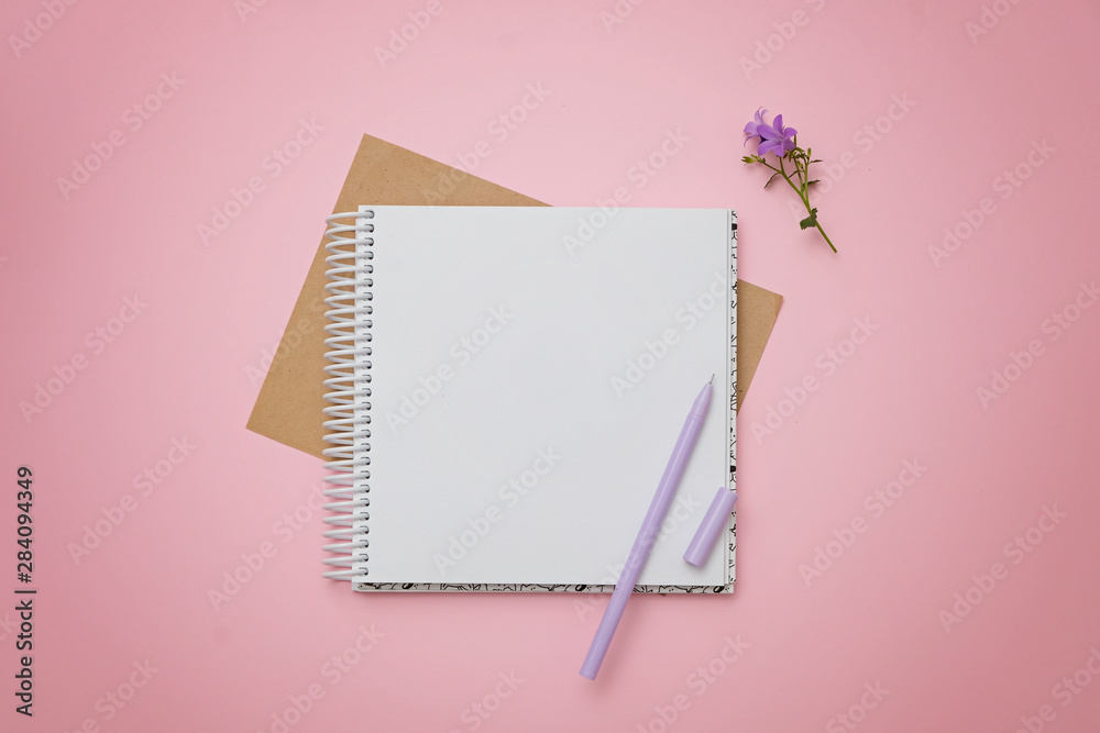Blank notepad, flowers and pen as mockup for your design. Pink background, flat lay style. Blank notepad, flowers and pen as mockup for your design. Pink background, flat lay style.
