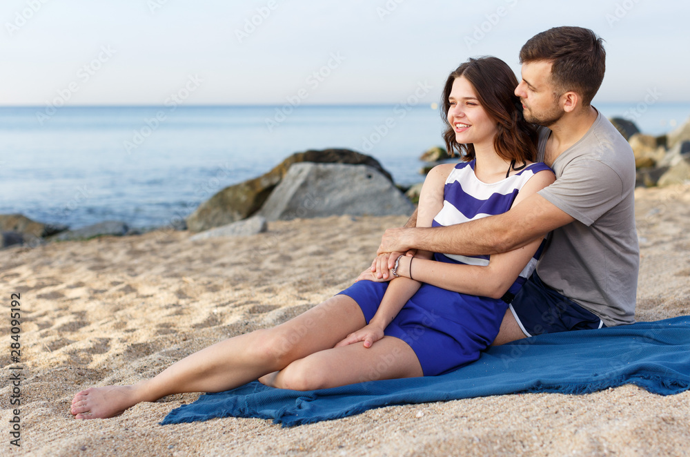 Positive loving couple resting and hugging