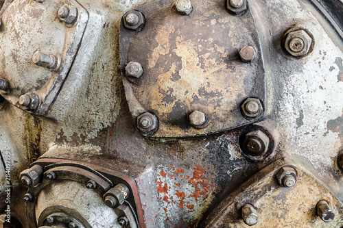 Abstract detail of steel industrial equipment with caps and bolts. Compressor air blower pumps. photo