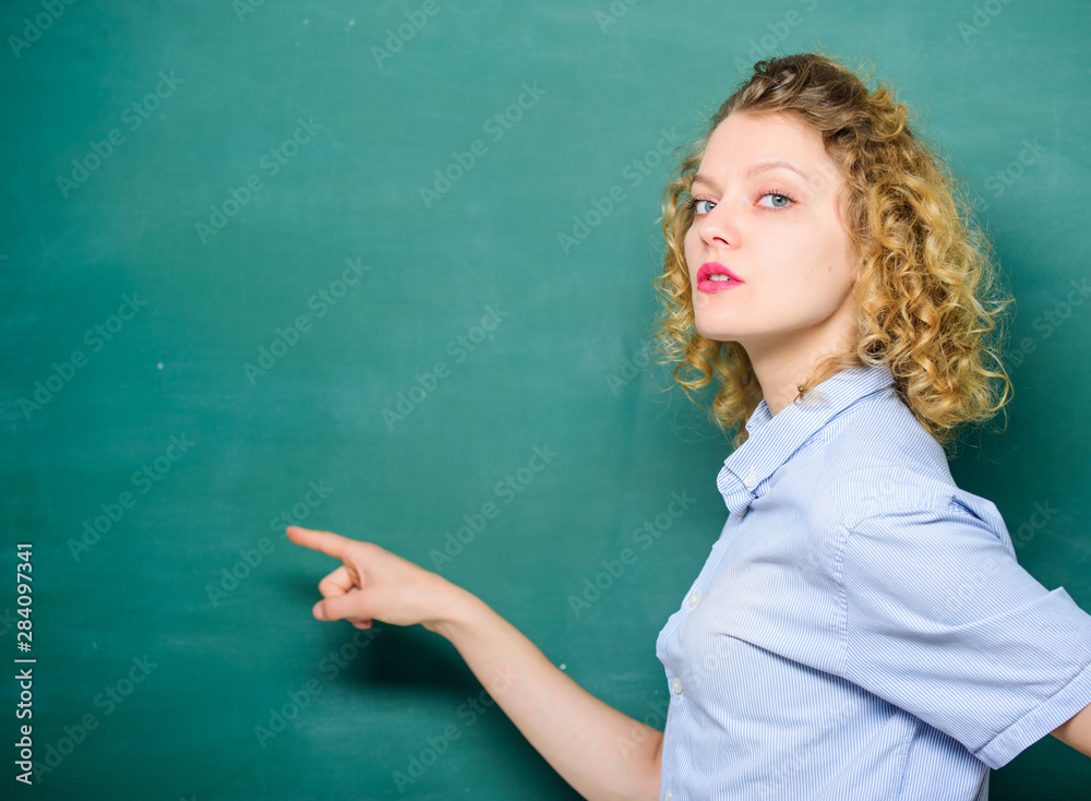 Look at this. knowledge day. empty blackboard information. education. Students life. woman teacher at school lesson. back to school. woman likes studying. student pointing at blackboard. copy space Look at this. knowledge day. empty blackboard information. education. Students life. woman teacher at school lesson. back to school. woman likes studying. student pointing at blackboard. copy space