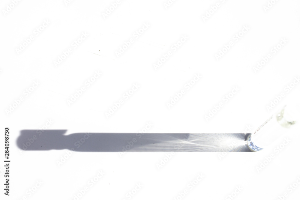Shadow from the sampler of perfume on a white background. Shadow from the sampler of perfume on a white background.