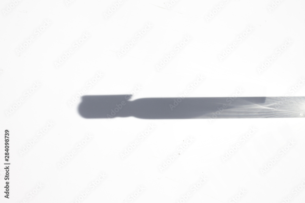 Shadow from the sampler of perfume on a white background. Shadow from the sampler of perfume on a white background.