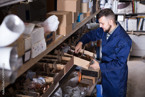 Charming man worker sorting sanitary engineering details