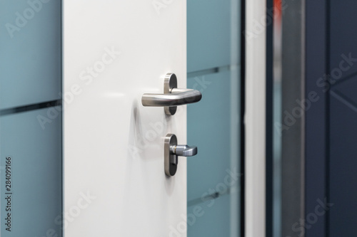 Close up photo of entrance door with a metal handle