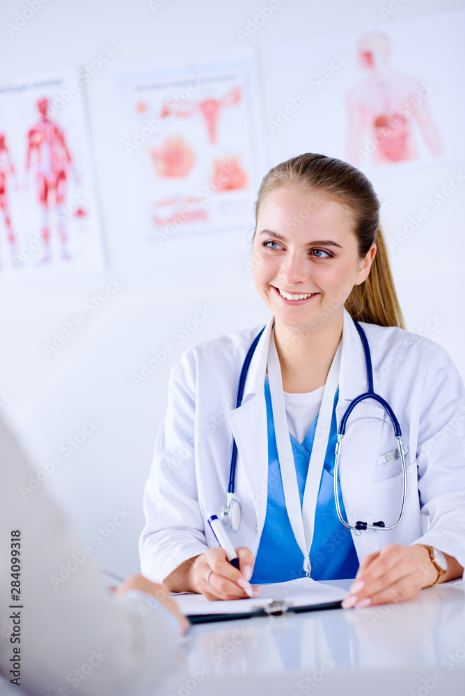 Doctor and patient are discussing something in medical office Doctor and patient are discussing something in medical office