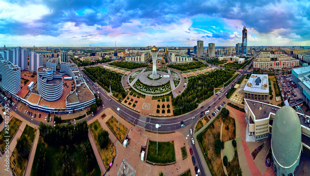 NUR-SULTAN, KAZAKHSTAN (QAZAQSTAN) - August 11, 2019: Beautiful panoramic aerial drone view to Nursultan (Astana) city center with skyscrapers and Baiterek Tower - symbol of Kazakh people freedom
