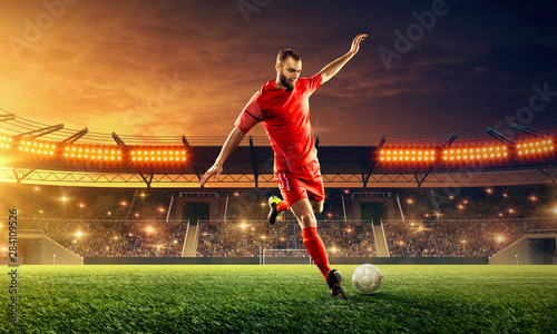Professional soccer kicks a ball on a soccer stadium. Soccer championship. Dramatic night sky
