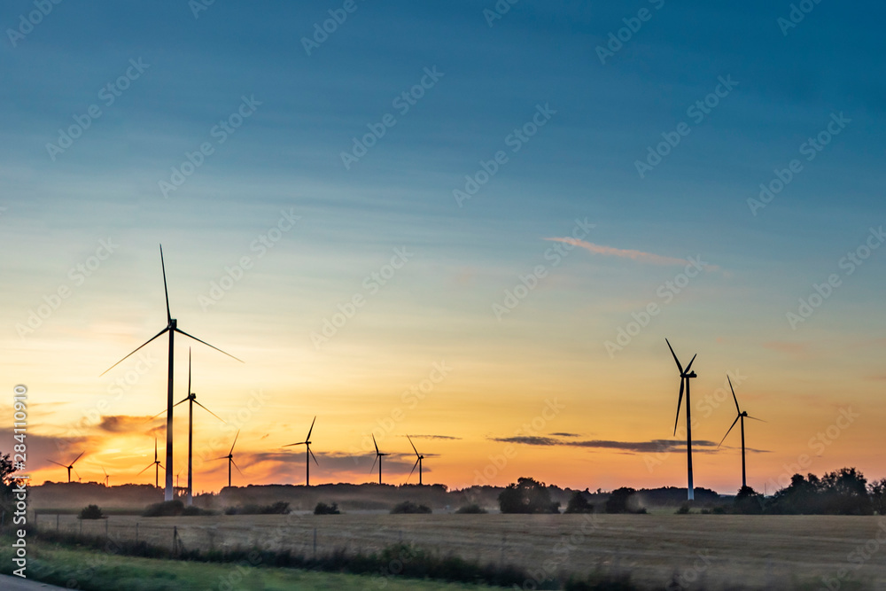 electric wind generators in sunset
