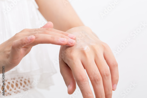Female applying cream to her hands