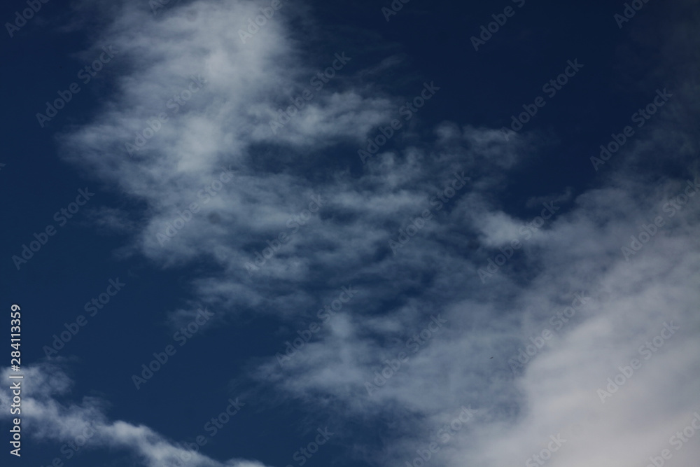 White clouds on dark blue background White clouds on dark blue background