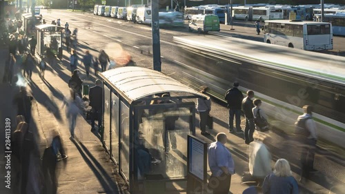 passengers waiting and boarding buses at the bus terminal, time lapse