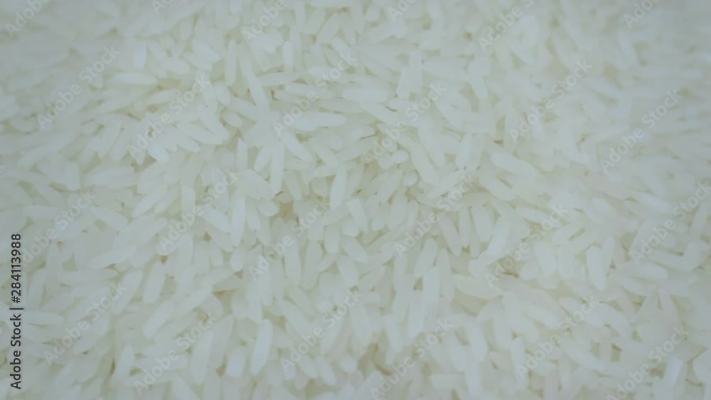 Extreme close up top view Rotation and falling down of dry raw unpolished brown rice, rice closeup,Pile of unpolished rice background Extreme close up top view Rotation and falling down of dry raw unpolished brown rice, rice closeup,Pile of unpolished rice background