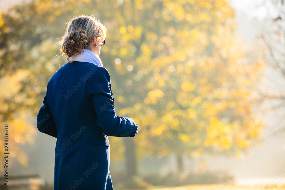 Middle-aged woman walking in city park