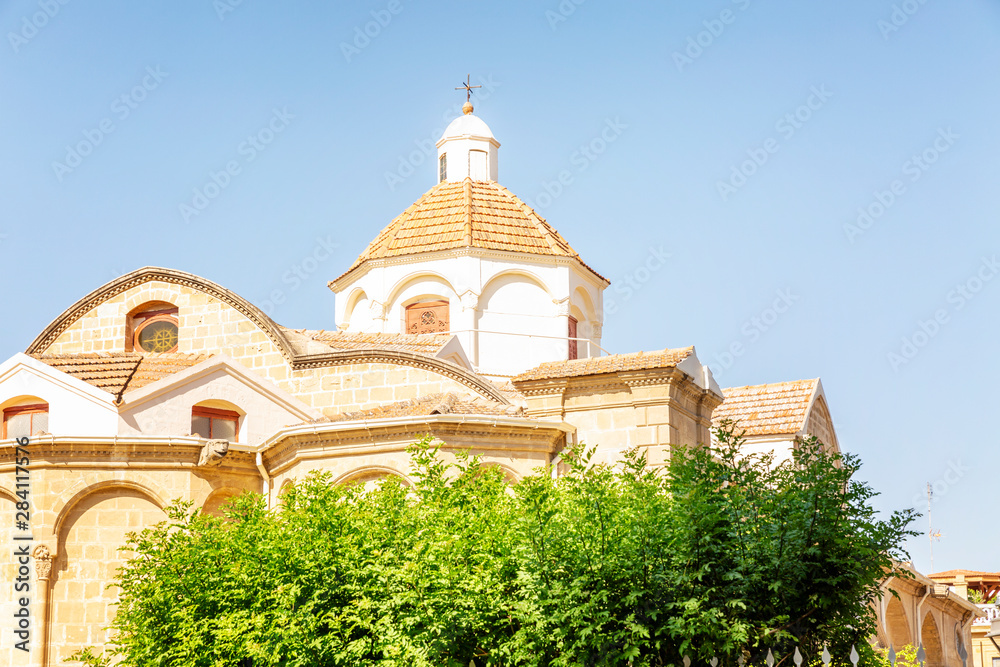 Beautiful greek church on a background of blue sky. Close-up. A clear sunny day.