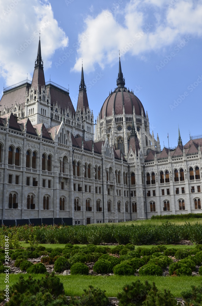 Budapest parliament on the background of the blue sky and green grass Budapest parliament on the background of the blue sky and green grass