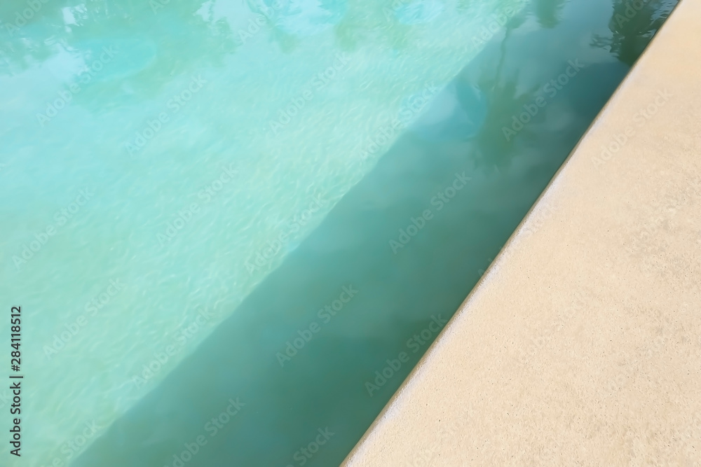 Abstract art of resort swimming pool water texture with surface and pattern effect in turquoise color summer background with depth shadow of the sand wash floor.