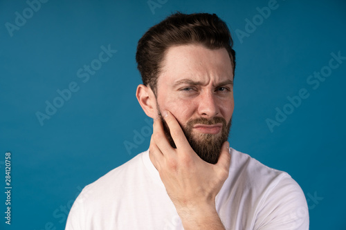 Photos Portrait of handsome boy who looks uncertain