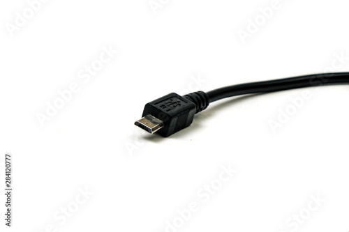 Micro usb black cable put on wooden table, it is small and short For portability. isolated on white background.
