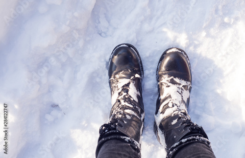 Boots on the snow, top view, winter time, winter sports and cold weather.