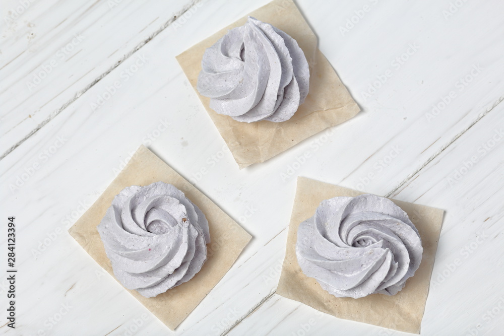 Freshly made lavender marshmallows on white painted boards. View from above.